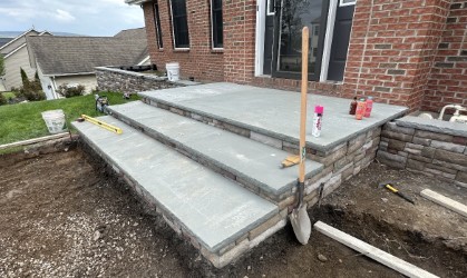 Thermal blue bluestone step treads installed on a front stoop at a brick home