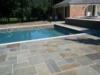Bluestone pool deck with bullnose coping around a swimming pool