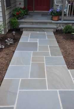 Blue pattern flagging walkway leading to a front door